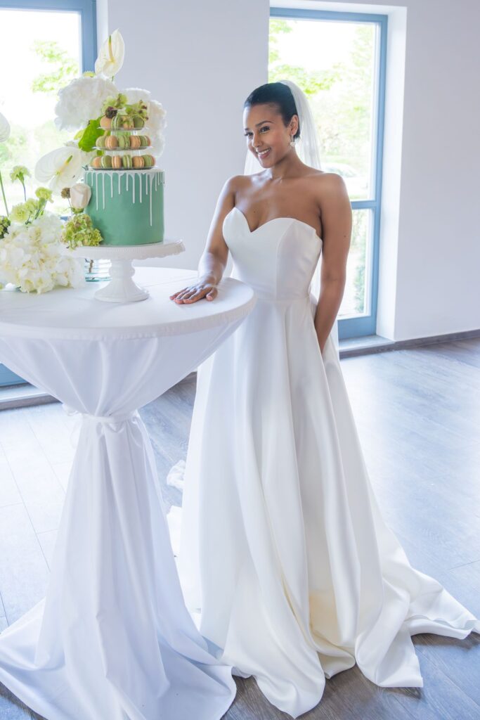 Brautpaar am festlich gedeckten Hochzeitstisch im Clean-Green-Stil