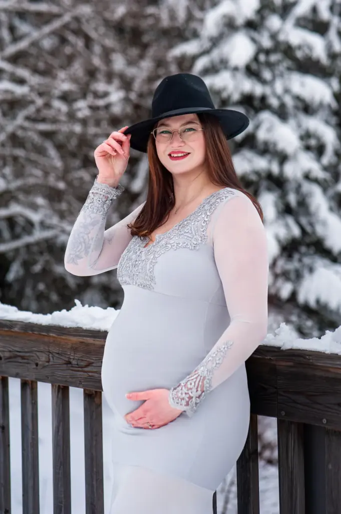 Schwangere Frau in fließendem Kleid im Winter